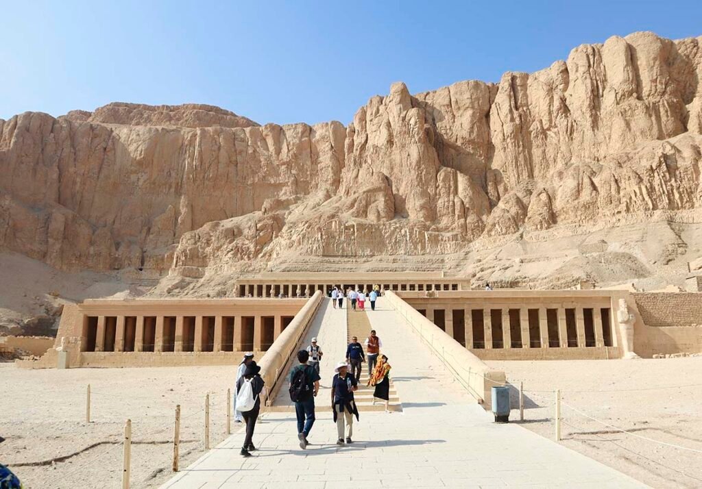 Daytime photograph of people waking out of the hatchepsut temple