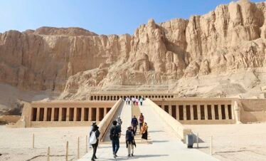 Daytime photograph of people waking out of the hatchepsut temple